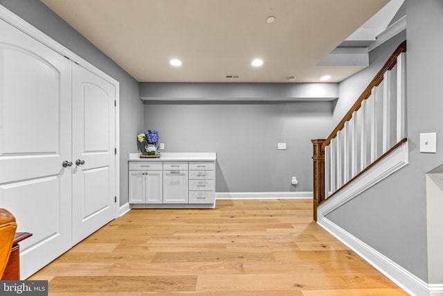 806 Dunfer Hill Rd, Severna Park, MD 21146 - bar featuring light wood-type flooring, stairway, and recessed lighting