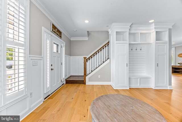 806 Dunfer Hill Rd, Severna Park, MD 21146 - entryway with stairs, light wood-type flooring, recessed lighting, ornamental molding, and a decorative wall