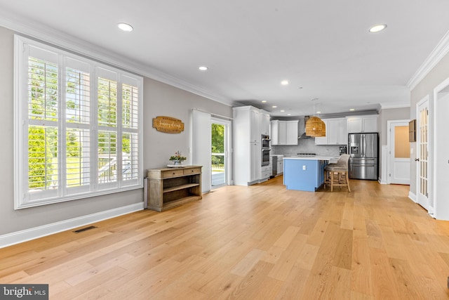 806 Dunfer Hill Rd, Severna Park, MD 21146 - kitchen featuring stainless steel fridge, crown molding, a breakfast bar, plenty of natural light, and light countertops