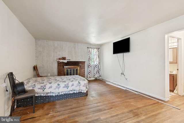 7022 High Bridge Rd, Bowie, MD 20720 - bedroom with wood finished floors, a brick fireplace, and connected bathroom
