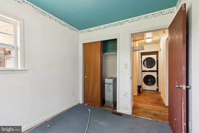 7022 High Bridge Rd, Bowie, MD 20720 - unfurnished bedroom with stacked washer and clothes dryer, carpet, and a closet