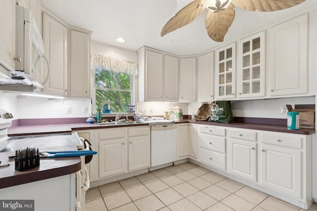 7022 High Bridge Rd, Bowie, MD 20720 - kitchen featuring white appliances, dark countertops, light tile patterned flooring, glass insert cabinets, and recessed lighting