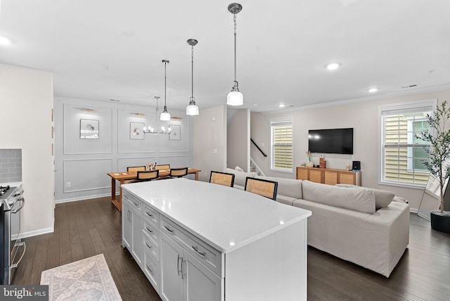 23230 Milltown Knoll Sq Unit 106, Ashburn, VA 20148 - kitchen with dark wood-style flooring, stainless steel gas range, a kitchen island, a chandelier, and hanging light fixtures