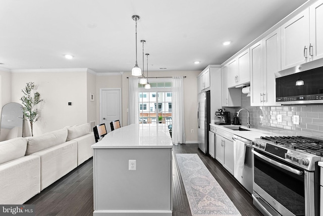 23230 Milltown Knoll Sq Unit 106, Ashburn, VA 20148 - kitchen featuring stainless steel appliances, a kitchen island, decorative backsplash, open floor plan, and white cabinets