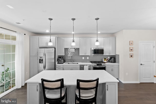 23230 Milltown Knoll Sq Unit 106, Ashburn, VA 20148 - kitchen with appliances with stainless steel finishes, dark wood-style floors, backsplash, light countertops, and recessed lighting