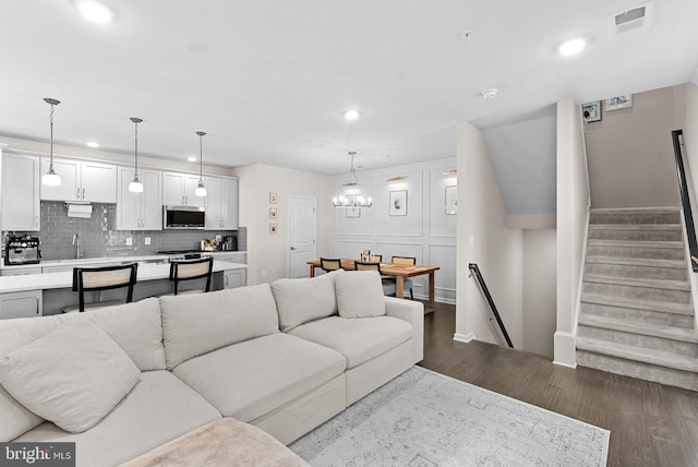 23230 Milltown Knoll Sq Unit 106, Ashburn, VA 20148 - living room with recessed lighting, dark wood-style flooring, a chandelier, and stairs