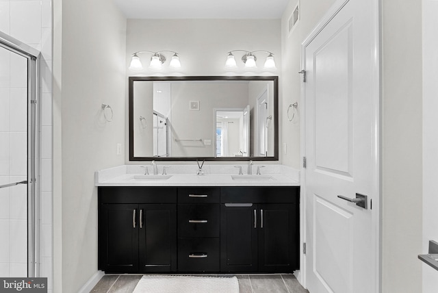 23230 Milltown Knoll Sq Unit 106, Ashburn, VA 20148 - bathroom featuring double vanity, a shower stall, and tile patterned floors
