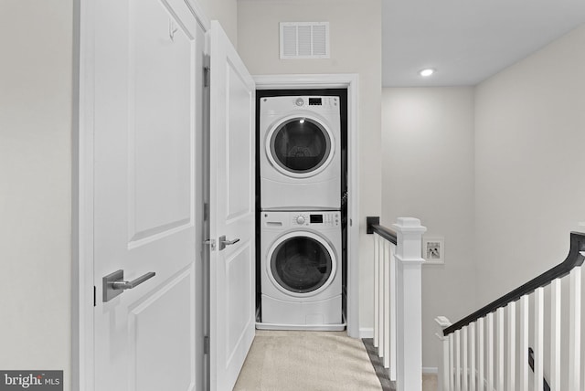 23230 Milltown Knoll Sq Unit 106, Ashburn, VA 20148 - laundry room featuring estacked washer and dryer and carpet