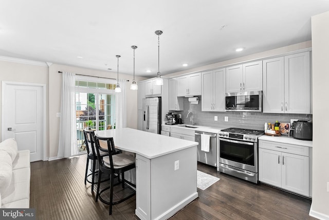 23230 Milltown Knoll Sq Unit 106, Ashburn, VA 20148 - kitchen featuring stainless steel appliances, a breakfast bar, a kitchen island, light countertops, and decorative backsplash