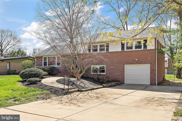 4662 Dartmoor Dr, Wilmington, DE 19803 - view of front of home with brick siding, an attached garage, and driveway