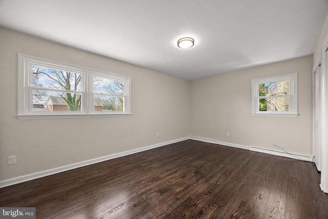 4662 Dartmoor Dr, Wilmington, DE 19803 - empty room with a baseboard heating unit and dark wood-style floors