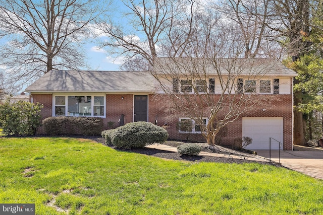 4662 Dartmoor Dr, Wilmington, DE 19803 - tri-level home featuring brick siding, an attached garage, driveway, and a front lawn