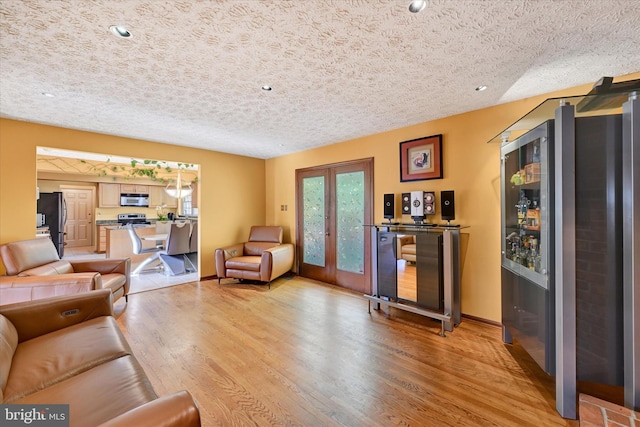 2700 Moores Valley Dr, Baltimore, MD 21209 - living area with light wood-style floors, a bar, recessed lighting, and a textured ceiling
