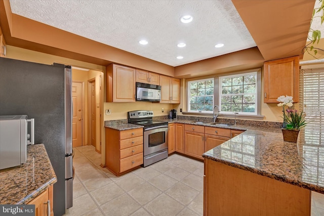 2700 Moores Valley Dr, Baltimore, MD 21209 - kitchen featuring stainless steel appliances, a textured ceiling, dark stone countertops, recessed lighting, and light tile patterned floors