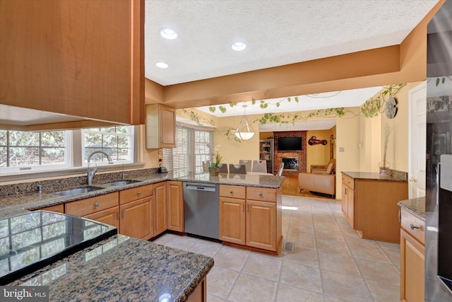 2700 Moores Valley Dr, Baltimore, MD 21209 - kitchen with stainless steel dishwasher, a fireplace, a peninsula, dark stone counters, and a textured ceiling