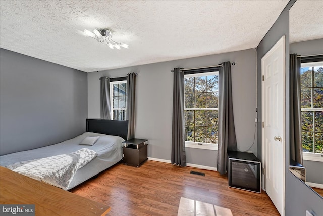 2700 Moores Valley Dr, Baltimore, MD 21209 - bedroom featuring wood finished floors and a textured ceiling
