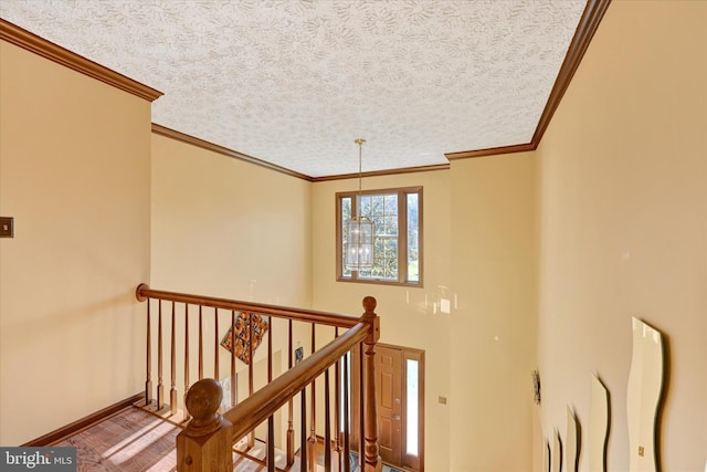 2700 Moores Valley Dr, Baltimore, MD 21209 - corridor featuring a textured ceiling, crown molding, an upstairs landing, and wood finished floors