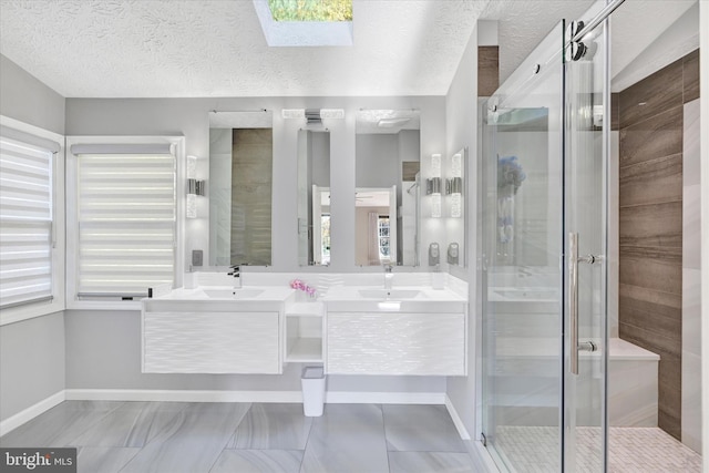 2700 Moores Valley Dr, Baltimore, MD 21209 - bathroom featuring double vanity, a shower stall, a skylight, a textured ceiling, and plenty of natural light