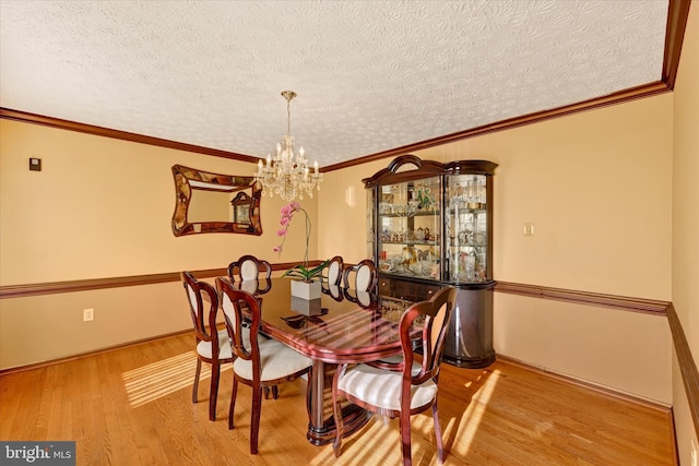 2700 Moores Valley Dr, Baltimore, MD 21209 - dining room featuring wood finished floors, a textured ceiling, a chandelier, and crown molding