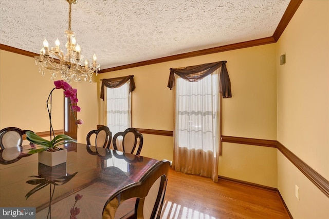 2700 Moores Valley Dr, Baltimore, MD 21209 - dining space featuring wood finished floors, a chandelier, crown molding, and a textured ceiling
