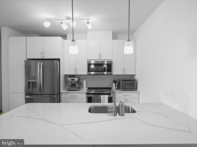 10755 Fairgrounds Dr Unit 223, Fairfax, VA 22030 - kitchen featuring stainless steel appliances, hanging light fixtures, white cabinets, and decorative backsplash