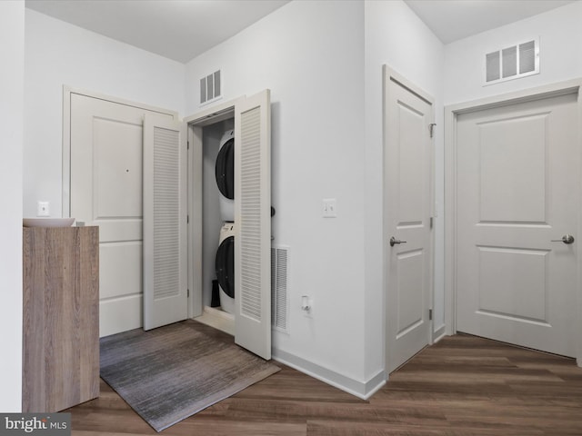 10755 Fairgrounds Dr Unit 223, Fairfax, VA 22030 - washroom featuring stacked washer and clothes dryer and wood finished floors