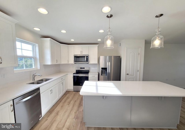 379 Eurasian Dr, Bunker Hill, WV 25413 - kitchen with stainless steel appliances, decorative backsplash, a kitchen island, recessed lighting, and white cabinets