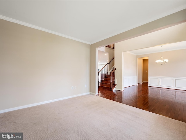 114 Renee Ln, Winchester, VA 22602 - carpeted empty room featuring a chandelier, crown molding, stairs, wood finished floors, and a wainscoted wall