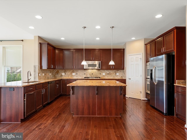 114 Renee Ln, Winchester, VA 22602 - kitchen with stainless steel appliances, a kitchen island, light stone countertops, dark wood-type flooring, and recessed lighting
