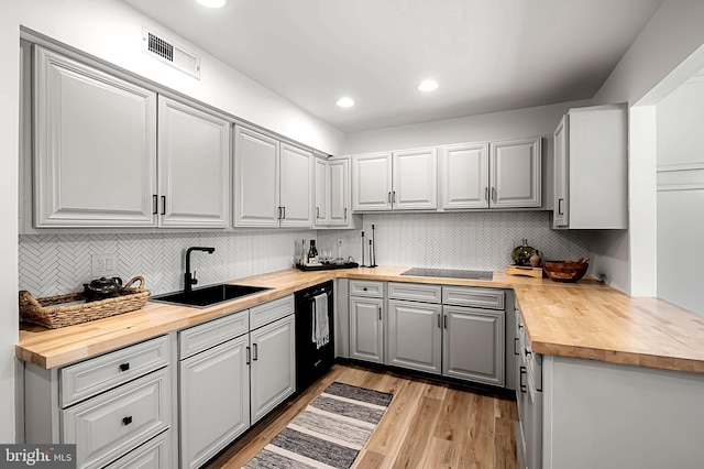 6128 Buckingham Manor Dr, Baltimore, MD 21210 - kitchen featuring butcher block counters, black appliances, gray cabinetry, tasteful backsplash, and recessed lighting
