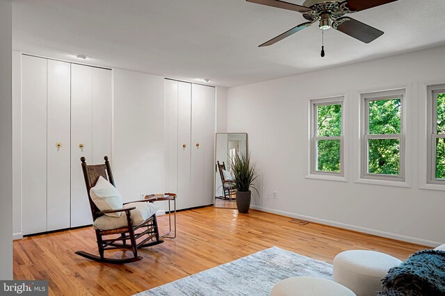 6128 Buckingham Manor Dr, Baltimore, MD 21210 - living area featuring light wood-style flooring and a ceiling fan