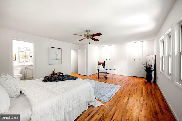 6128 Buckingham Manor Dr, Baltimore, MD 21210 - bedroom featuring two closets, wood finished floors, ensuite bathroom, and ceiling fan