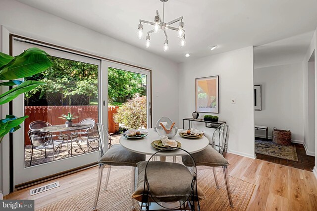 6128 Buckingham Manor Dr, Baltimore, MD 21210 - dining room with light wood-type flooring and a chandelier