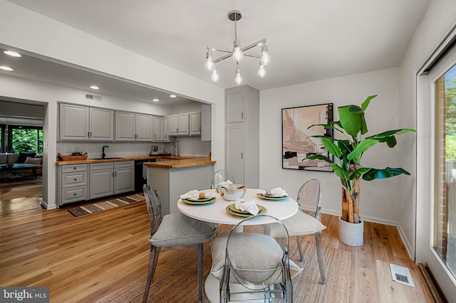 6128 Buckingham Manor Dr, Baltimore, MD 21210 - dining room with a chandelier, light wood finished floors, and recessed lighting