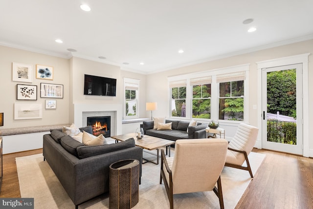 2407 N Nelson St, Arlington, VA 22207 - living area with light wood-style floors, a warm lit fireplace, recessed lighting, healthy amount of natural light, and crown molding