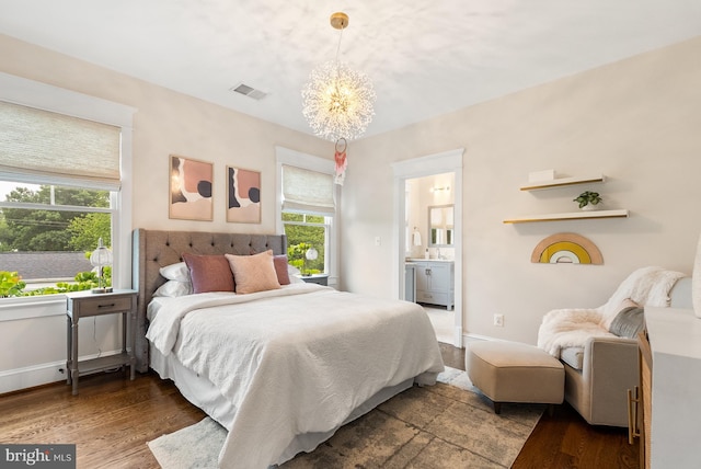 2407 N Nelson St, Arlington, VA 22207 - bedroom with a chandelier, wood finished floors, and connected bathroom