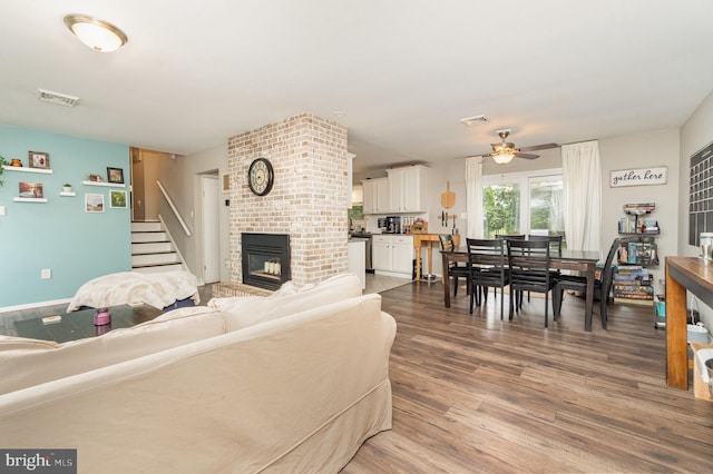 30 Bunker Ln, Etters, PA 17319 - living area with a ceiling fan, a brick fireplace, wood finished floors, and stairs