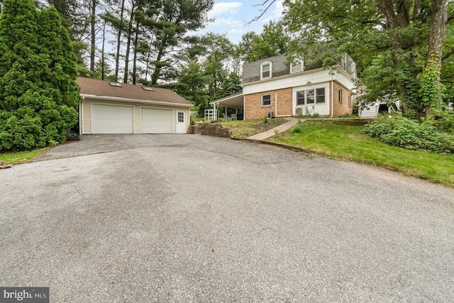 30 Bunker Ln, Etters, PA 17319 - view of front of home featuring a detached garage, an outdoor structure, brick siding, and mansard roof