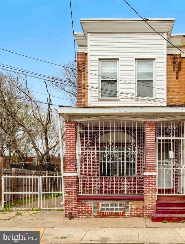 1245 Chase St, Camden, NJ 08104 - view of front facade with brick siding and a porch