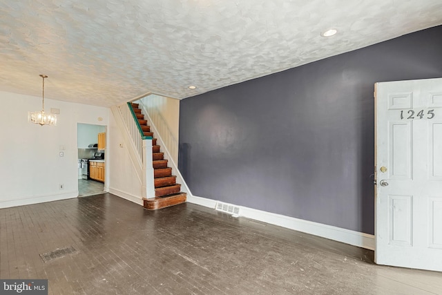 1245 Chase St, Camden, NJ 08104 - unfurnished living room featuring stairs, a chandelier, wood finished floors, a textured ceiling, and recessed lighting