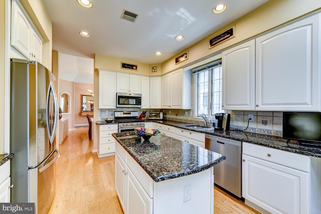 57 Harwood Rd, Monroe Township, NJ 08831 - kitchen with appliances with stainless steel finishes, dark stone countertops, backsplash, white cabinetry, and recessed lighting