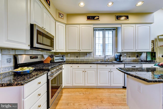 57 Harwood Rd, Monroe Township, NJ 08831 - kitchen featuring appliances with stainless steel finishes, white cabinetry, dark stone countertops, and recessed lighting