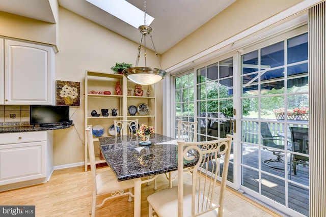 57 Harwood Rd, Monroe Township, NJ 08831 - dining area featuring light wood finished floors, lofted ceiling, and a skylight