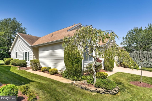 57 Harwood Rd, Monroe Township, NJ 08831 - view of side of property featuring driveway, a lawn, and a shingled roof