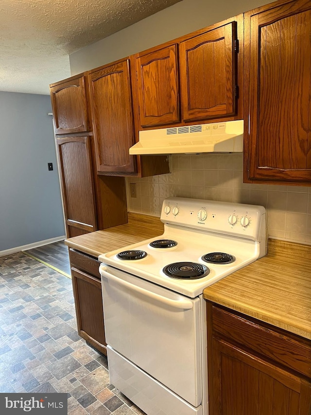 2177 Fawn Ct, Waldorf, MD 20602 - kitchen with white range with electric stovetop, under cabinet range hood, light countertops, tasteful backsplash, and a textured ceiling