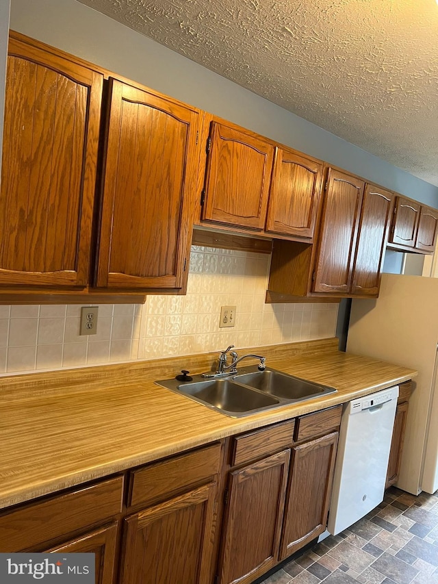 2177 Fawn Ct, Waldorf, MD 20602 - kitchen featuring dishwasher, tasteful backsplash, light countertops, a textured ceiling, and brown cabinetry