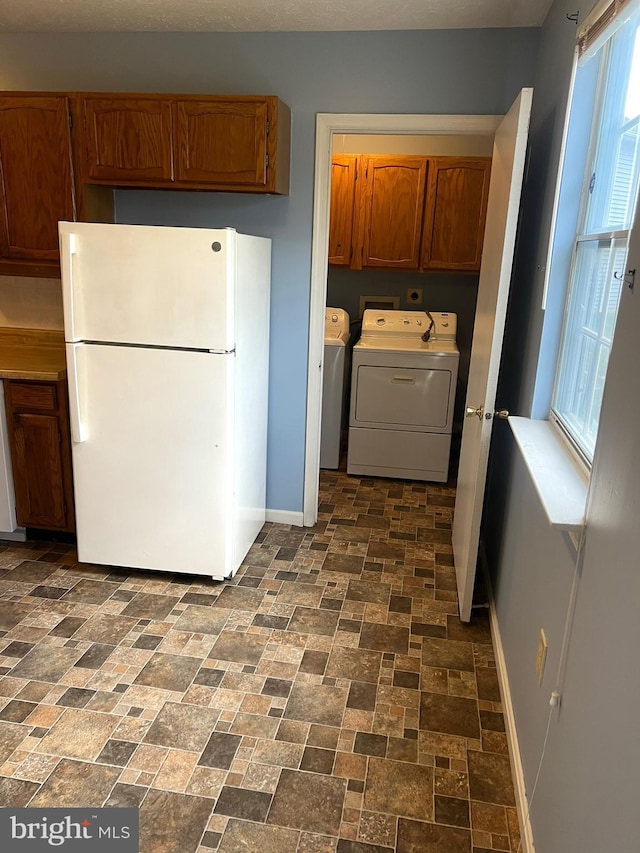2177 Fawn Ct, Waldorf, MD 20602 - laundry area with cabinet space, independent washer and dryer, brick patterned floors, and healthy amount of natural light