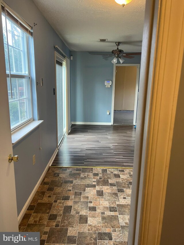 2177 Fawn Ct, Waldorf, MD 20602 - corridor featuring plenty of natural light, brick patterned flooring, and a textured ceiling