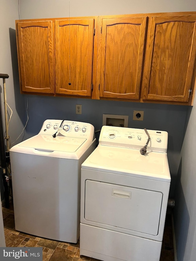 2177 Fawn Ct, Waldorf, MD 20602 - laundry area featuring washer and clothes dryer, cabinet space, and dark stone finish floors