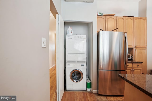 2117 N St NW Unit 2, Washington, DC 20037 - laundry room with stacked washer / drying machine and light wood-type flooring